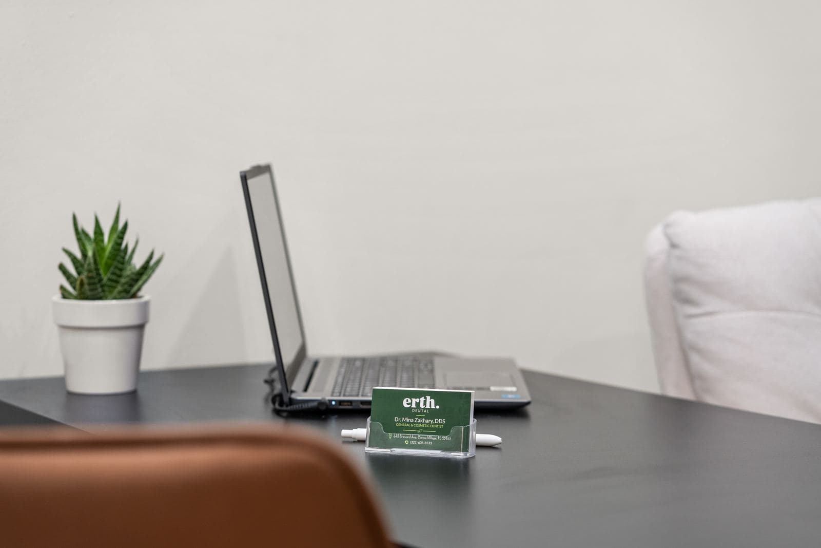 A consultation desk at erth. dental with Dr. Zakhary's business card